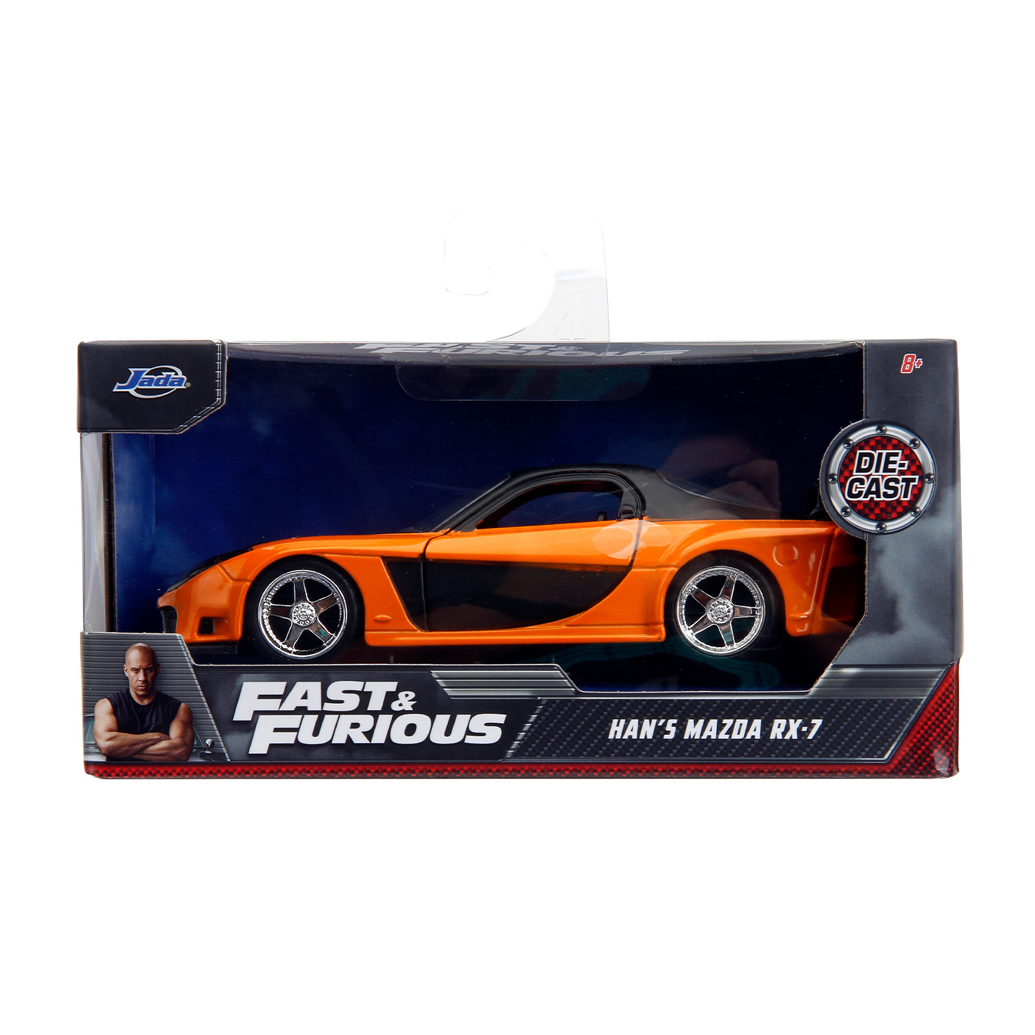 Macchina giocattolo arancione e nera in scatola con marchio Fast & Furious e immagine di Vin Diesel.