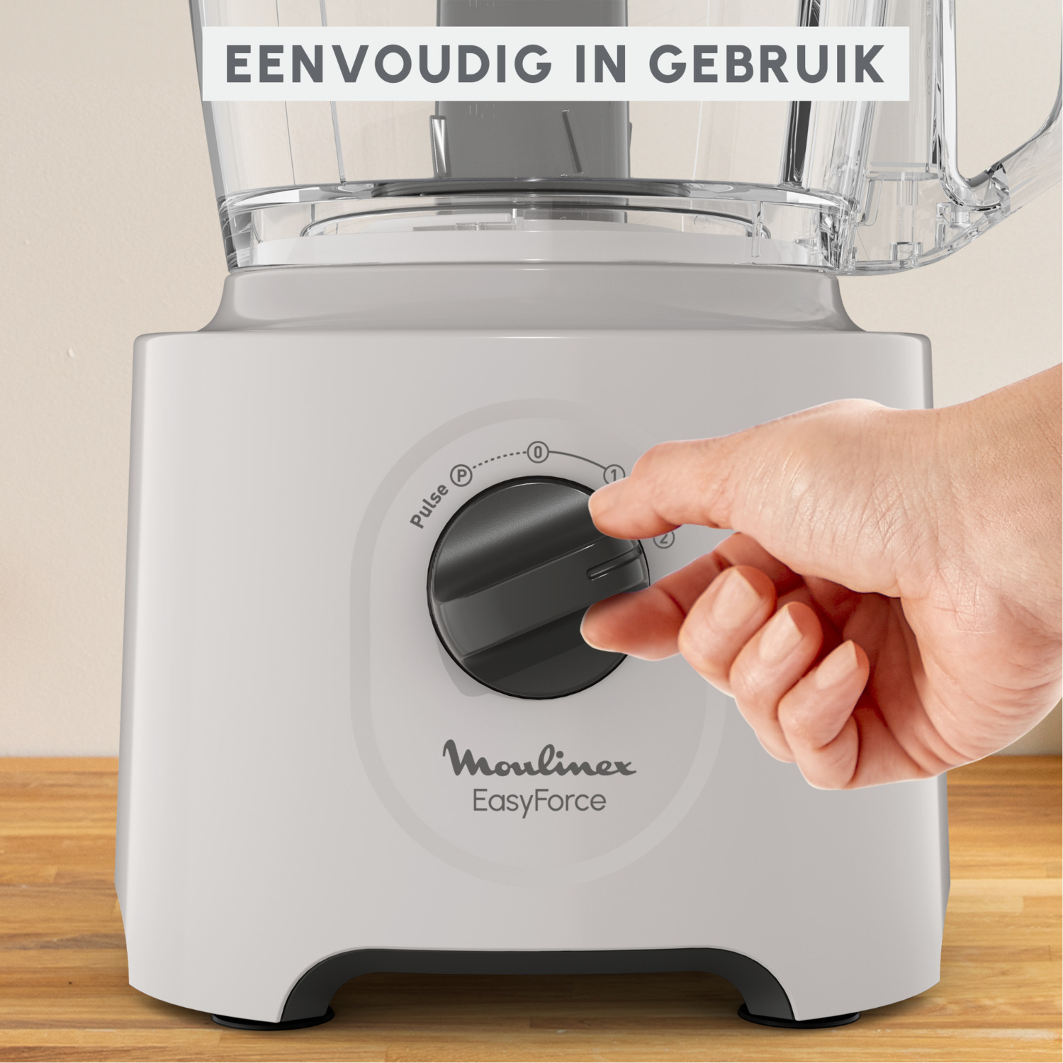 A hand turning the dial on a white and grey Moulinex EasyForce food processor. The text says 'EasyForce'.