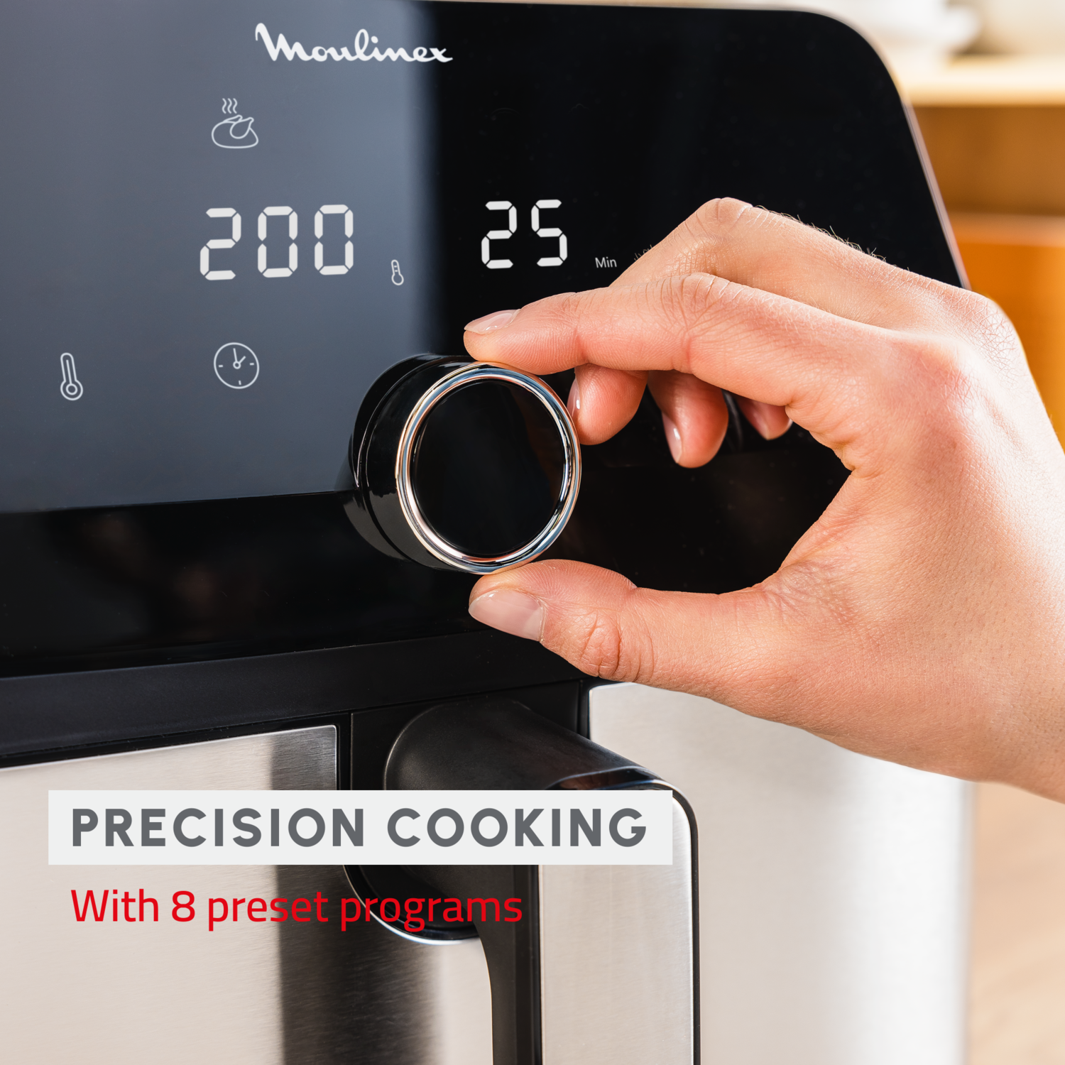 Air fryer with a hand turning the dial, showing settings and temperature.