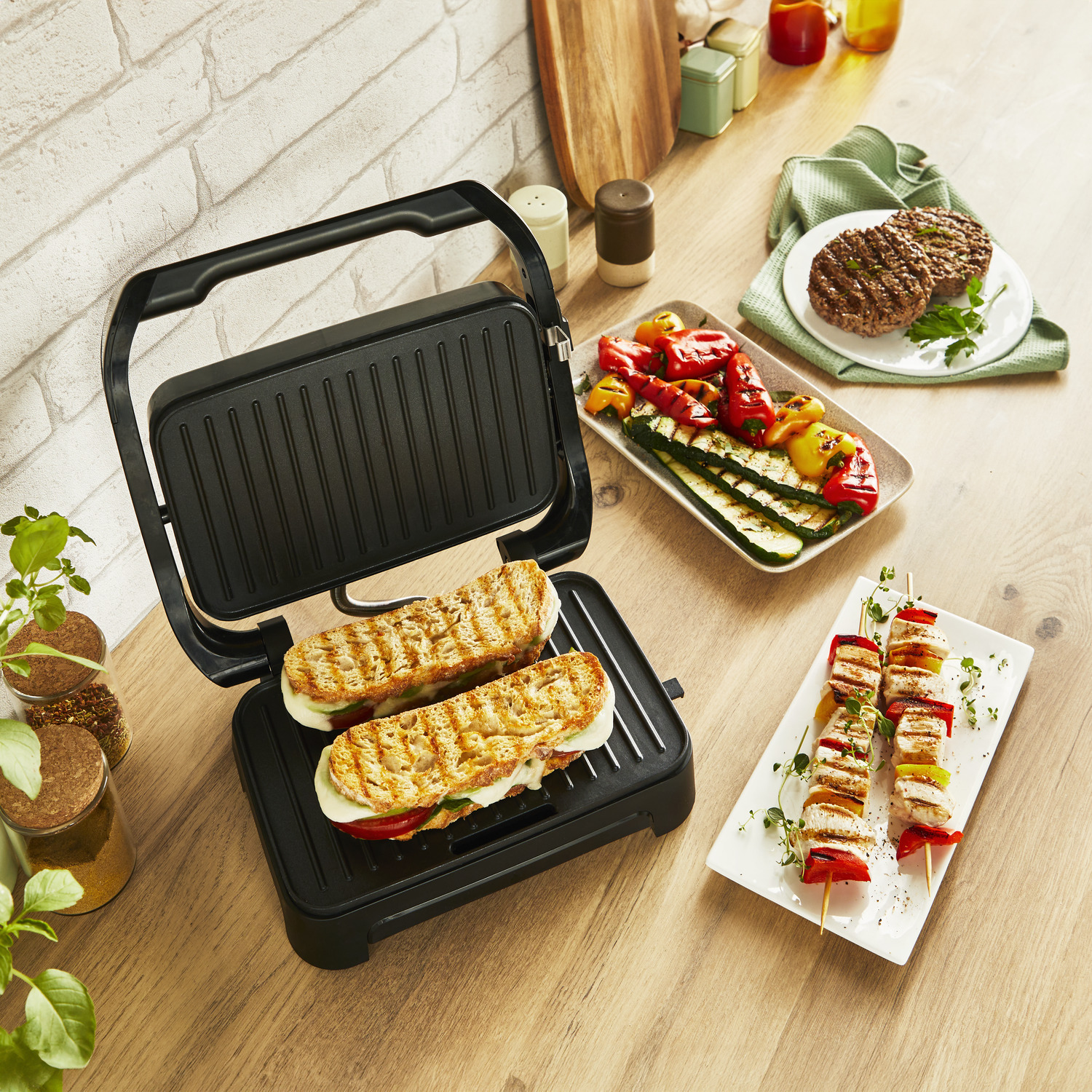 Grill met sandwiches en spiesjes, met gegrilde groenten en burgers op een tafel.
