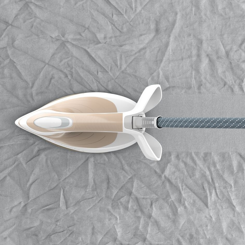Żelazko na desce do prasowania. Żelazko jest białe z beżowymi akcentami i szarym kablem w kropki.