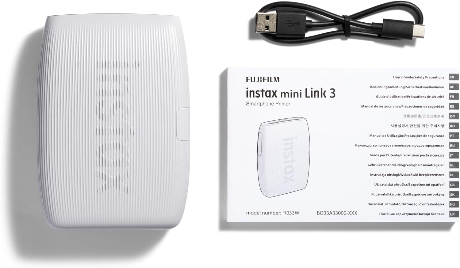 Fehér Fujifilm Instax Mini Link 3 nyomtató, USB-C kábel és felhasználói útmutató, mind fehér alapon.