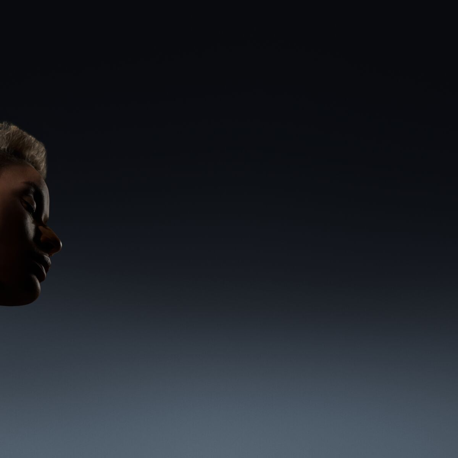 Silhouette of a person's face. Profile view, dark background, light hair.
