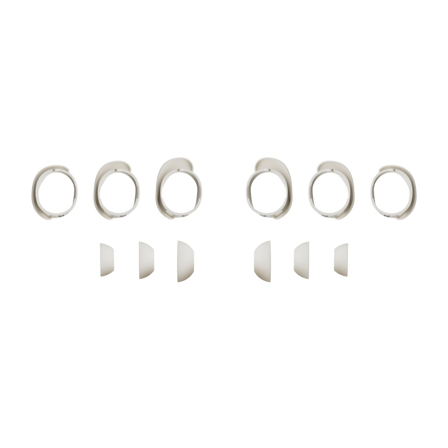 Six silver ear tips. Two sets of three, with a few white earbud components.