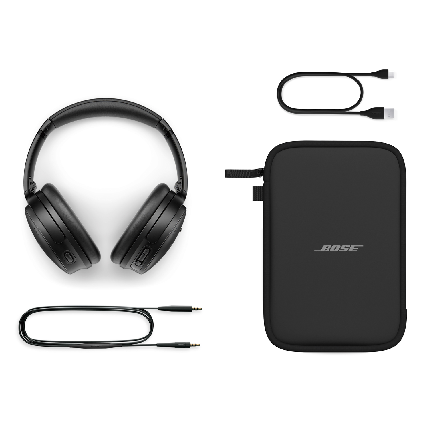Black headphones, charging cables, and a black carrying case, all neatly arranged on a white surface.