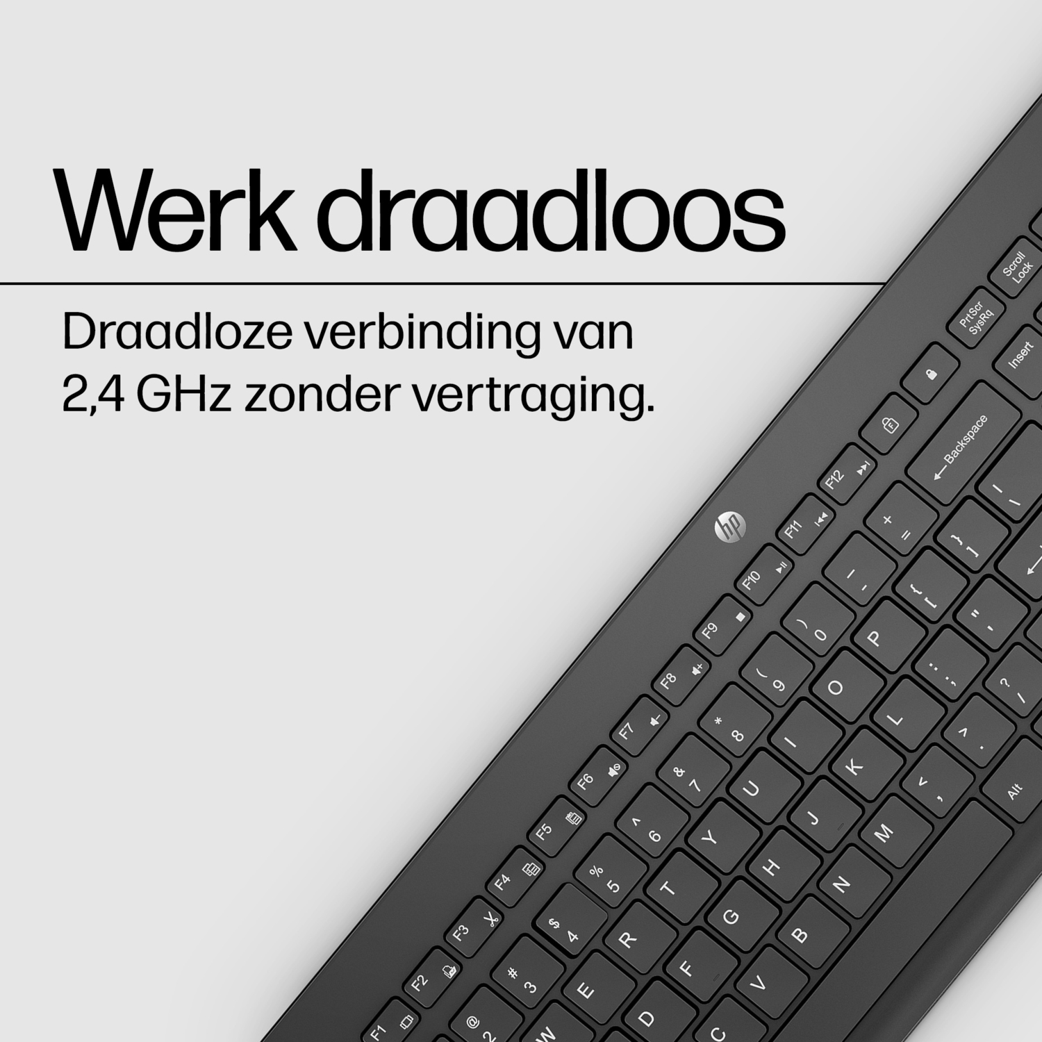 Black keyboard with white text, angled towards the viewer, with text 'Werk draadloos' at the top.