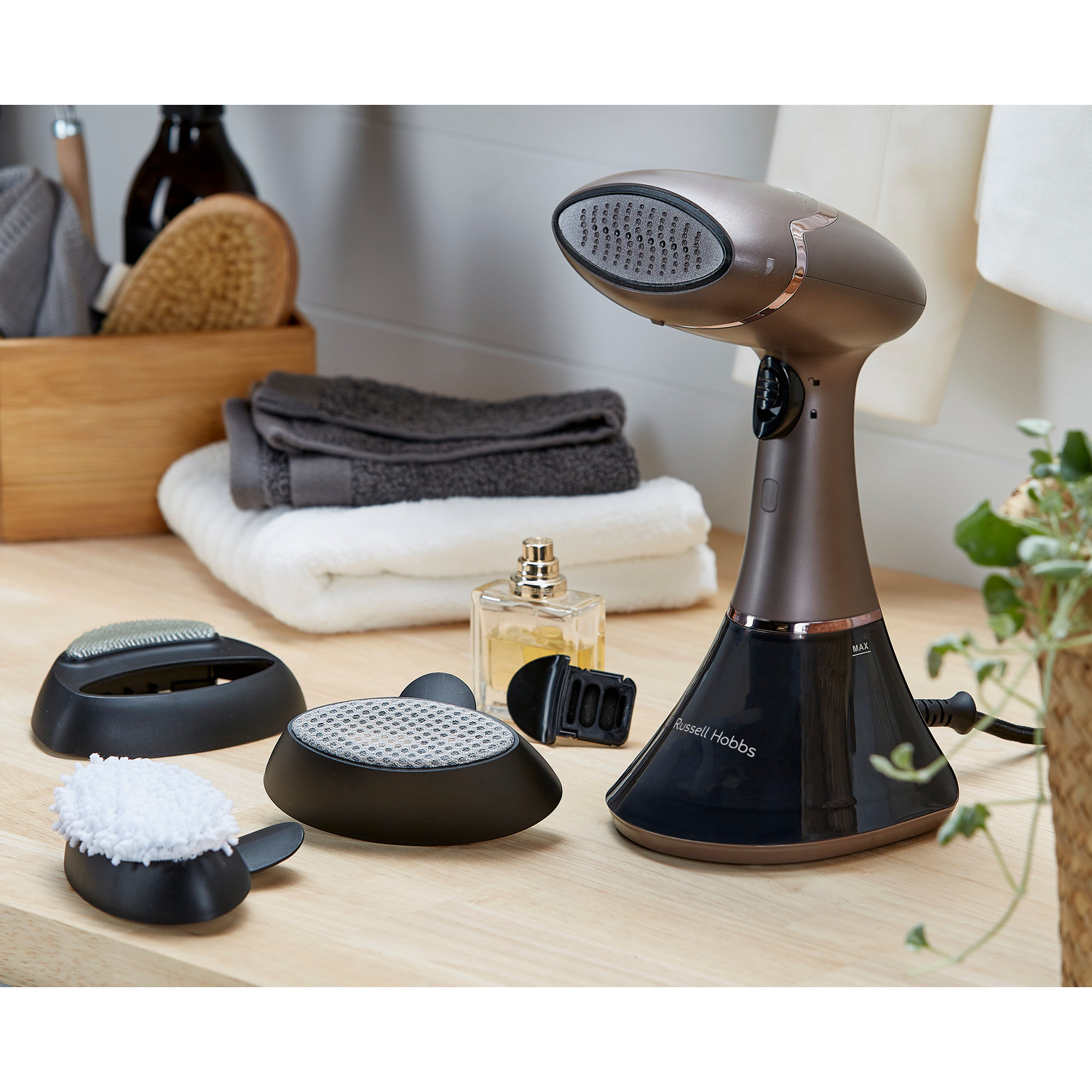 A steam cleaner with attachments and accessories. The items are displayed on a white surface.