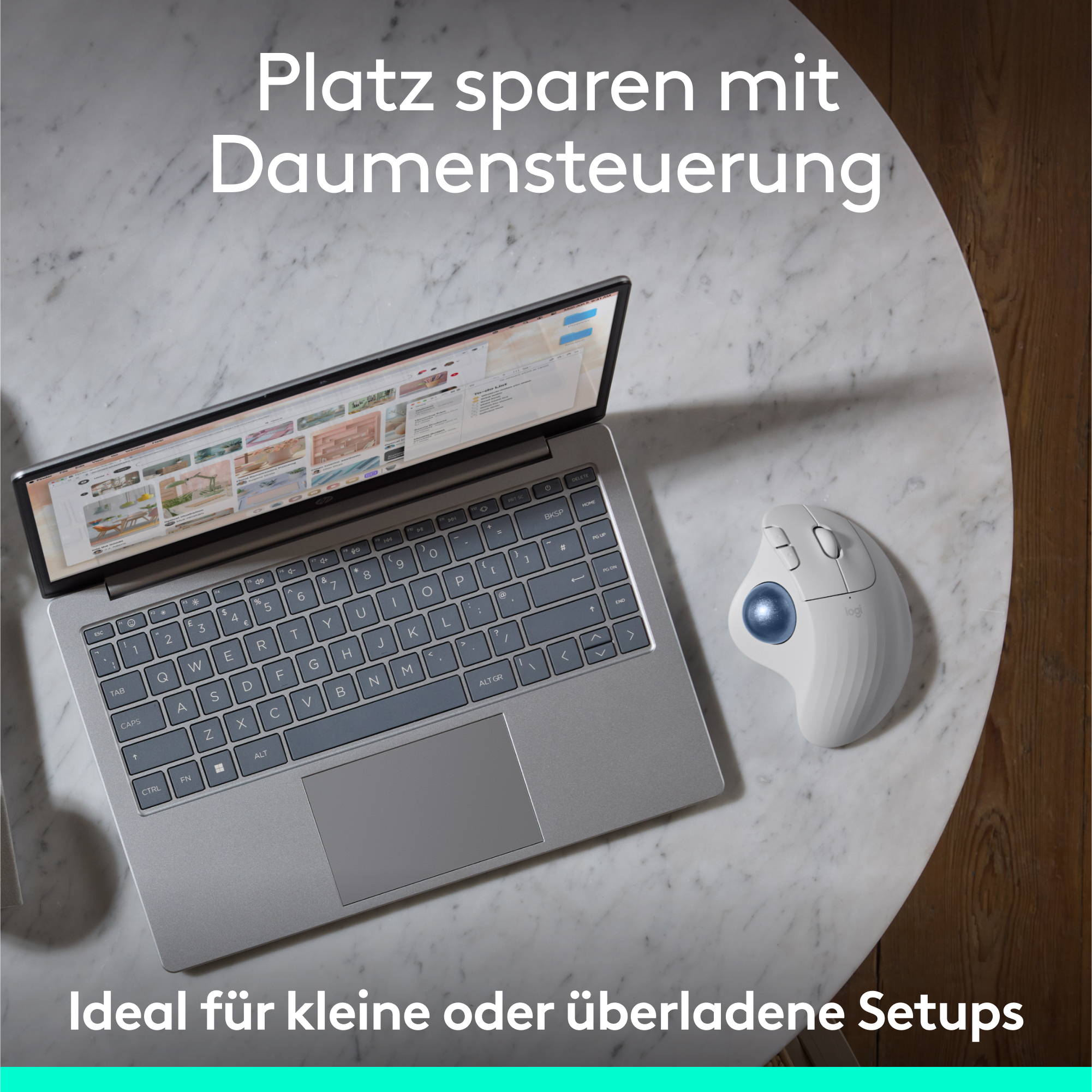 Ein Laptop mit einer Trackball-Maus daneben, beides auf einer Marmoroberfläche, Draufsicht.