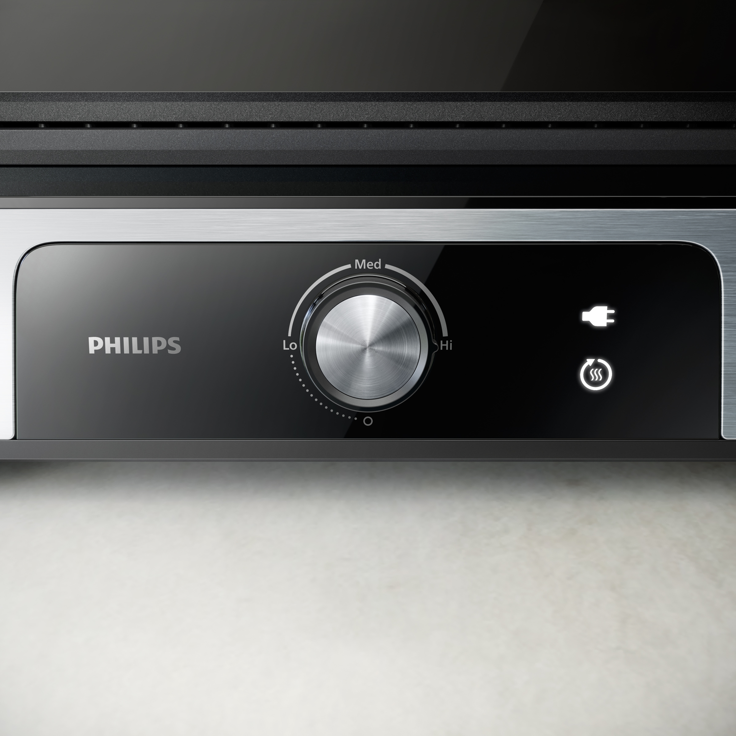 Close-up of Philips appliance control panel with power and temperature settings.