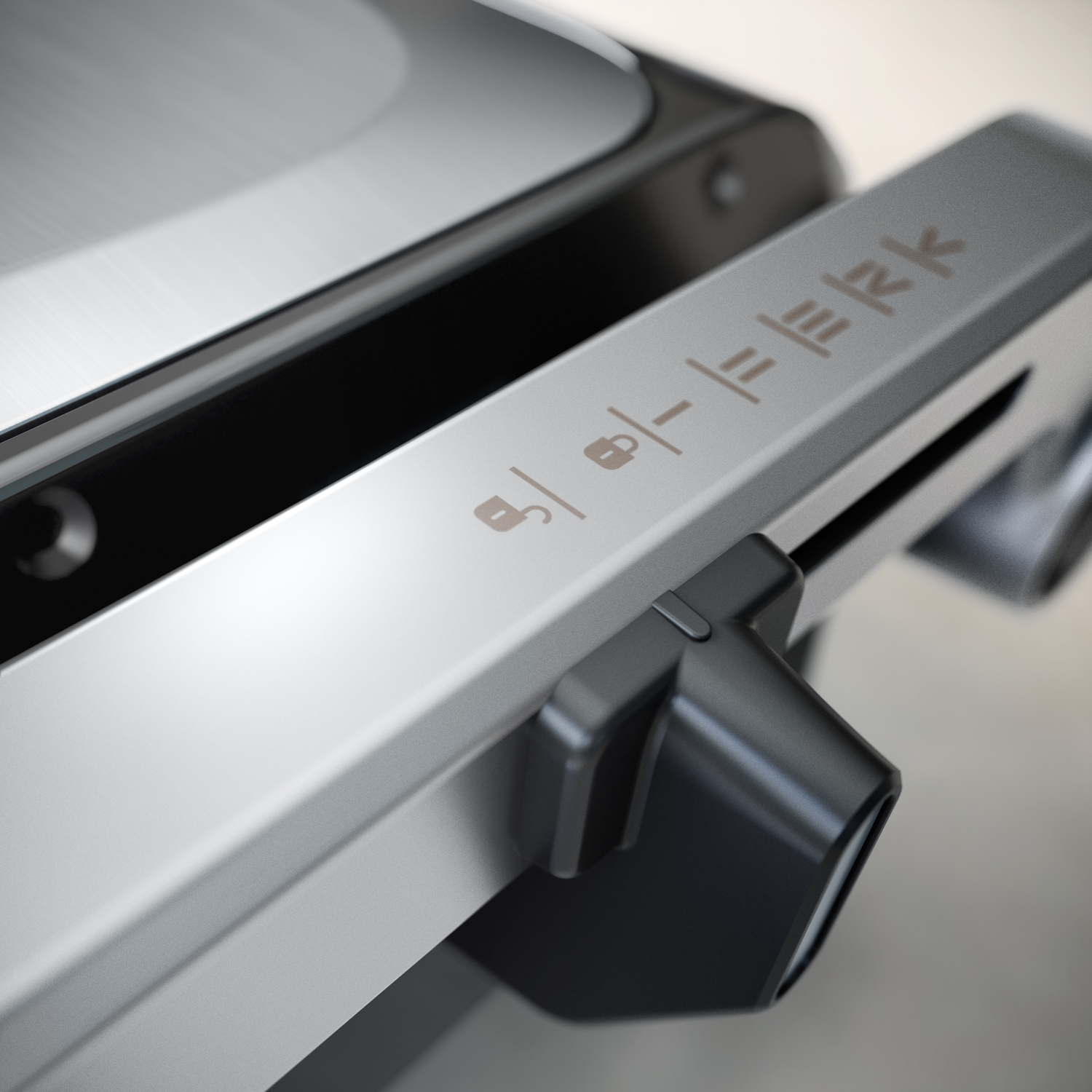 Close-up of a silver and black electronic device with symbols and text.