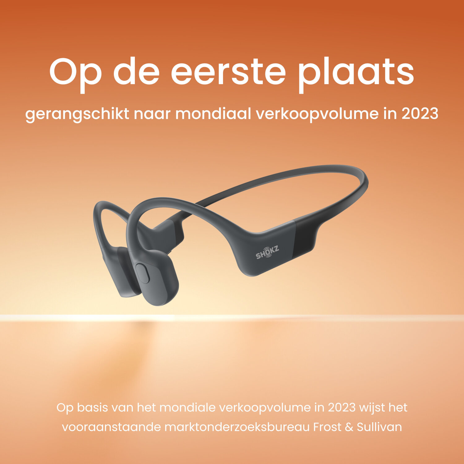 Zwarte botgeleidende koptelefoon, Nederlandse tekst en oranje achtergrond.