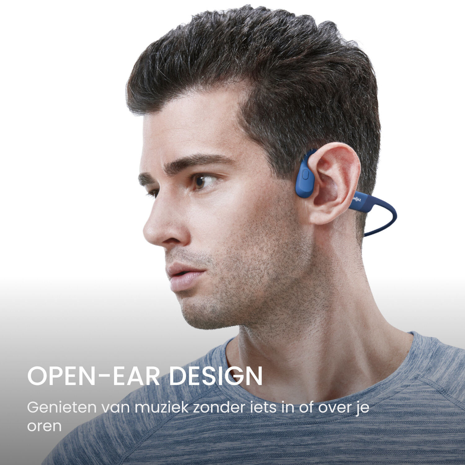 Man wearing blue open-ear headphones, showing the side profile of his face.