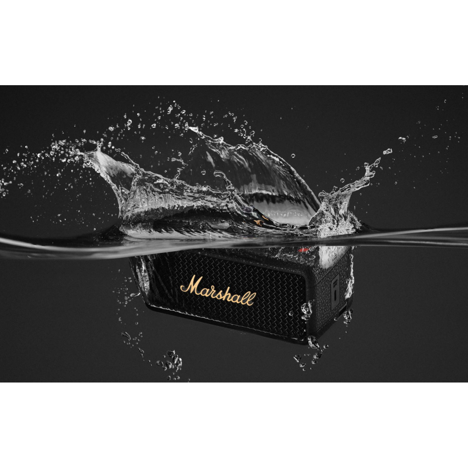 Black Marshall speaker submerged in water with splash. Black background.
