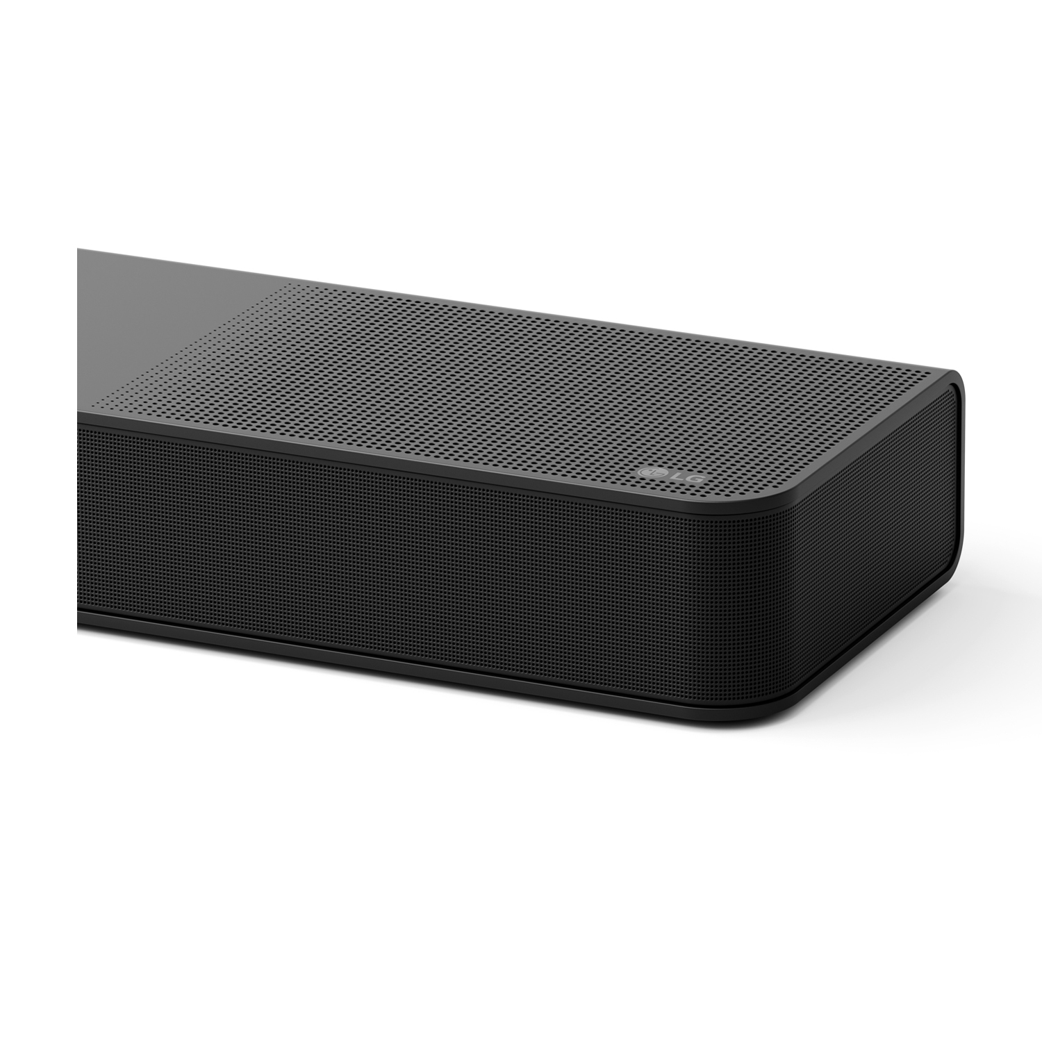 Una soundbar nera, con una parte anteriore a griglia, appoggiata su una superficie bianca.