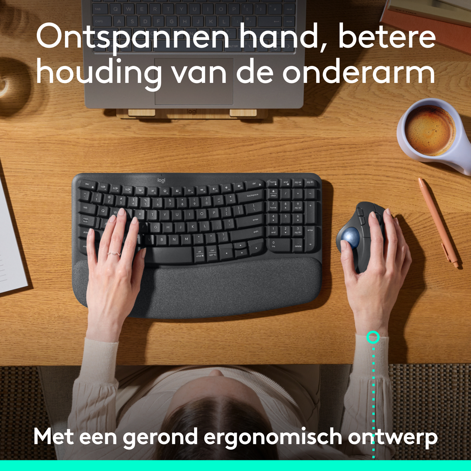 Person typing on an ergonomic keyboard. Desk with mouse and pen.