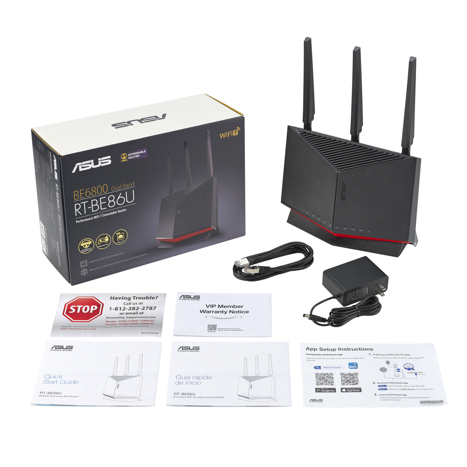 A router box with its parts, including a router, cables, and manuals.