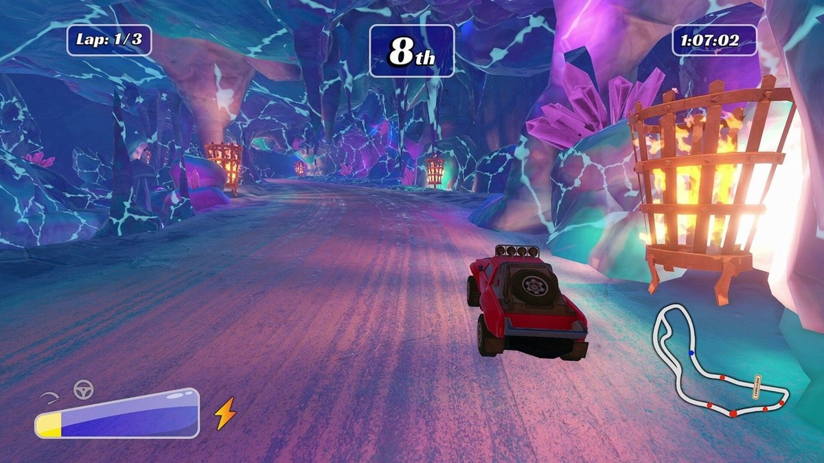 Een rode terreinwagen racet in een grot met blauwe en paarse kristalformaties en fakkels.