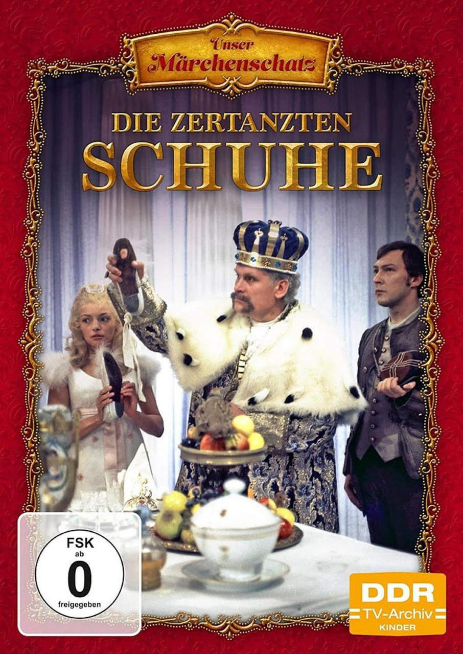 Filmplakat. Zeigt einen König, der einen Schuh hält. Andere schauen ihn an.