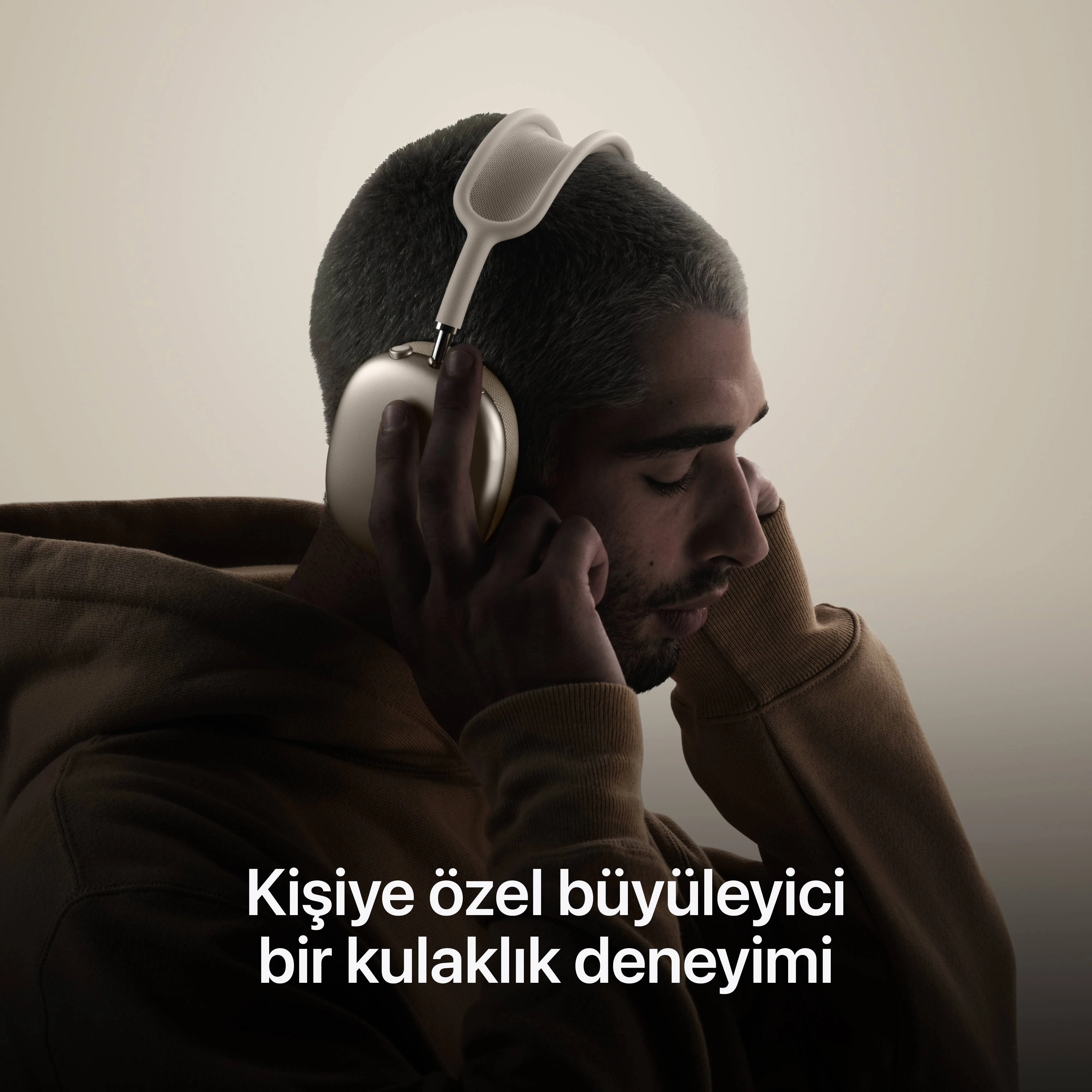 Beyaz kulaklık takan bir adam, beyaz renkteki “Kişiselleştirilmiş bir deneyim” sloganıyla.