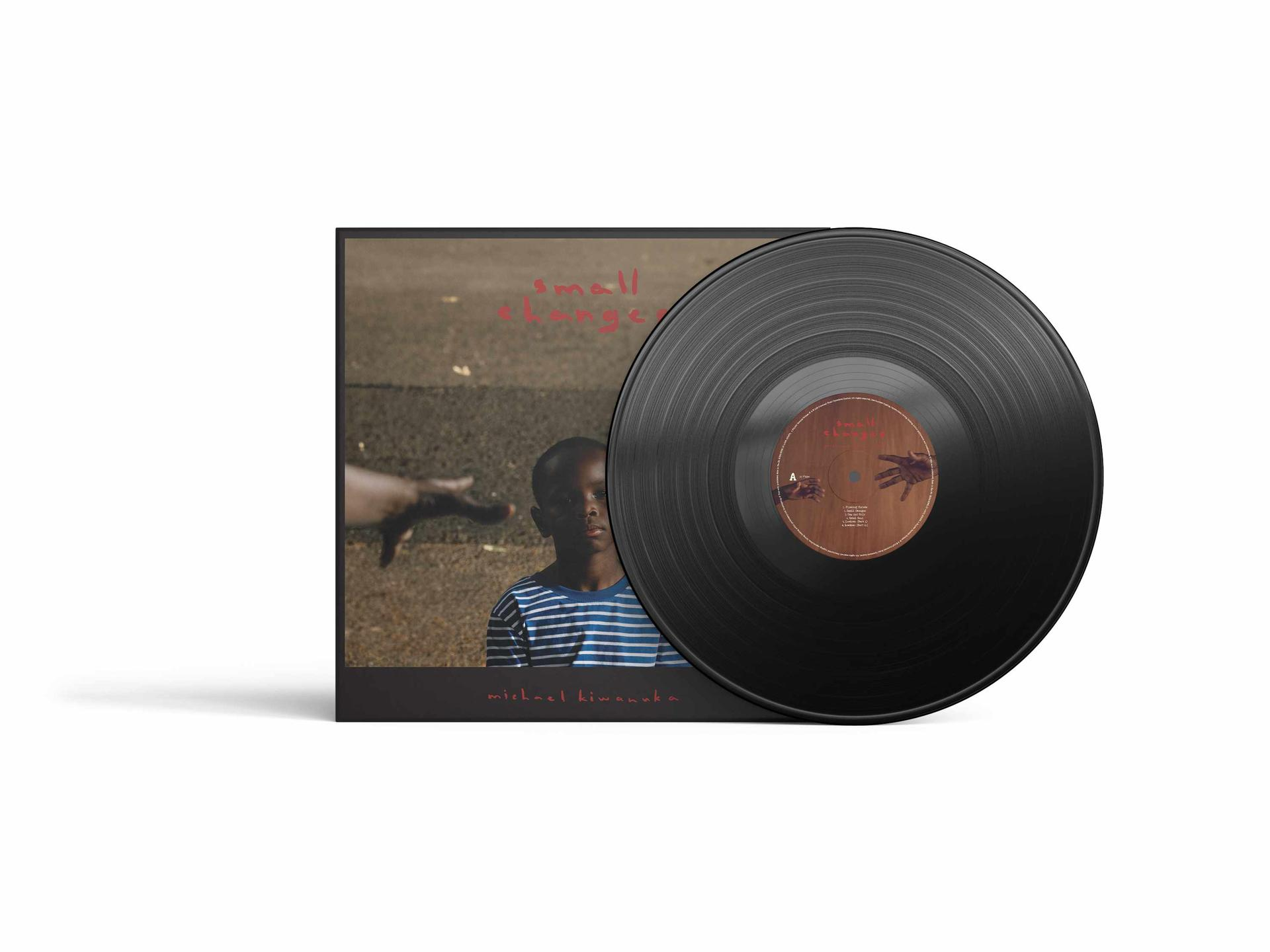 Vinylplaat en albumhoes. Album toont een zwart kind en een hand.