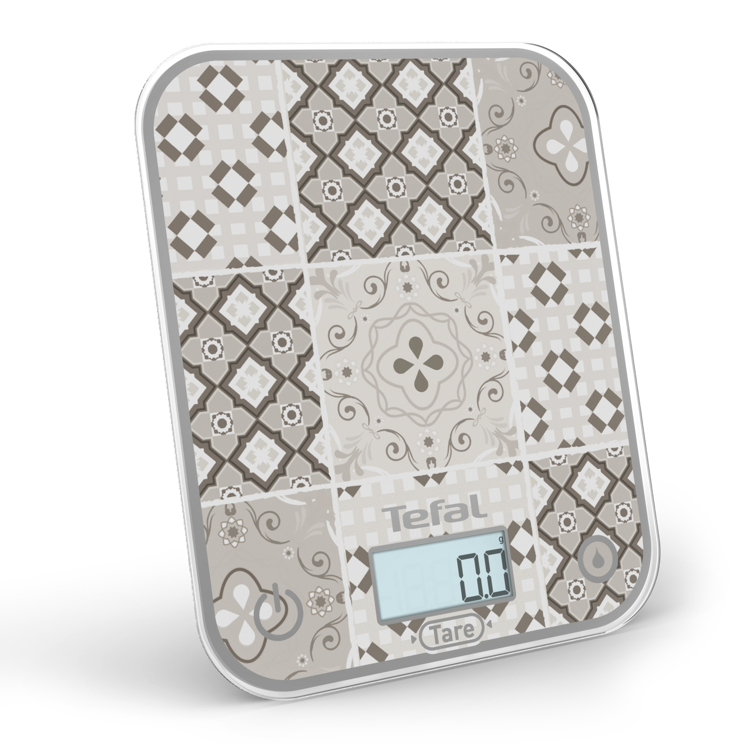 Balance de cuisine numérique avec surface à motifs, affichant '0.0'. La marque 'Tefal' est visible.