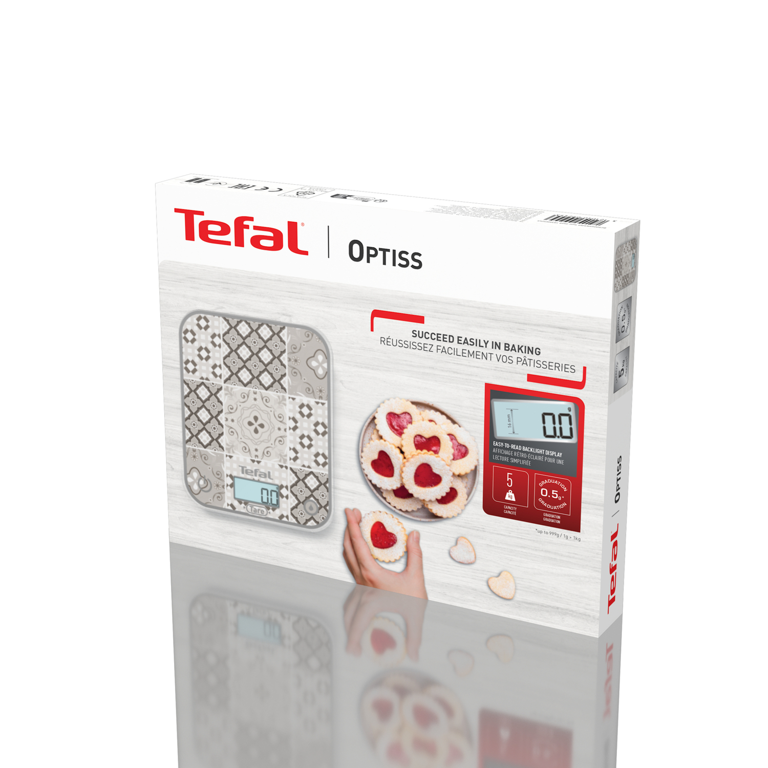 Boîte de balance de cuisine Tefal Optiss avec biscuits, écran et main tenant un biscuit blanc.