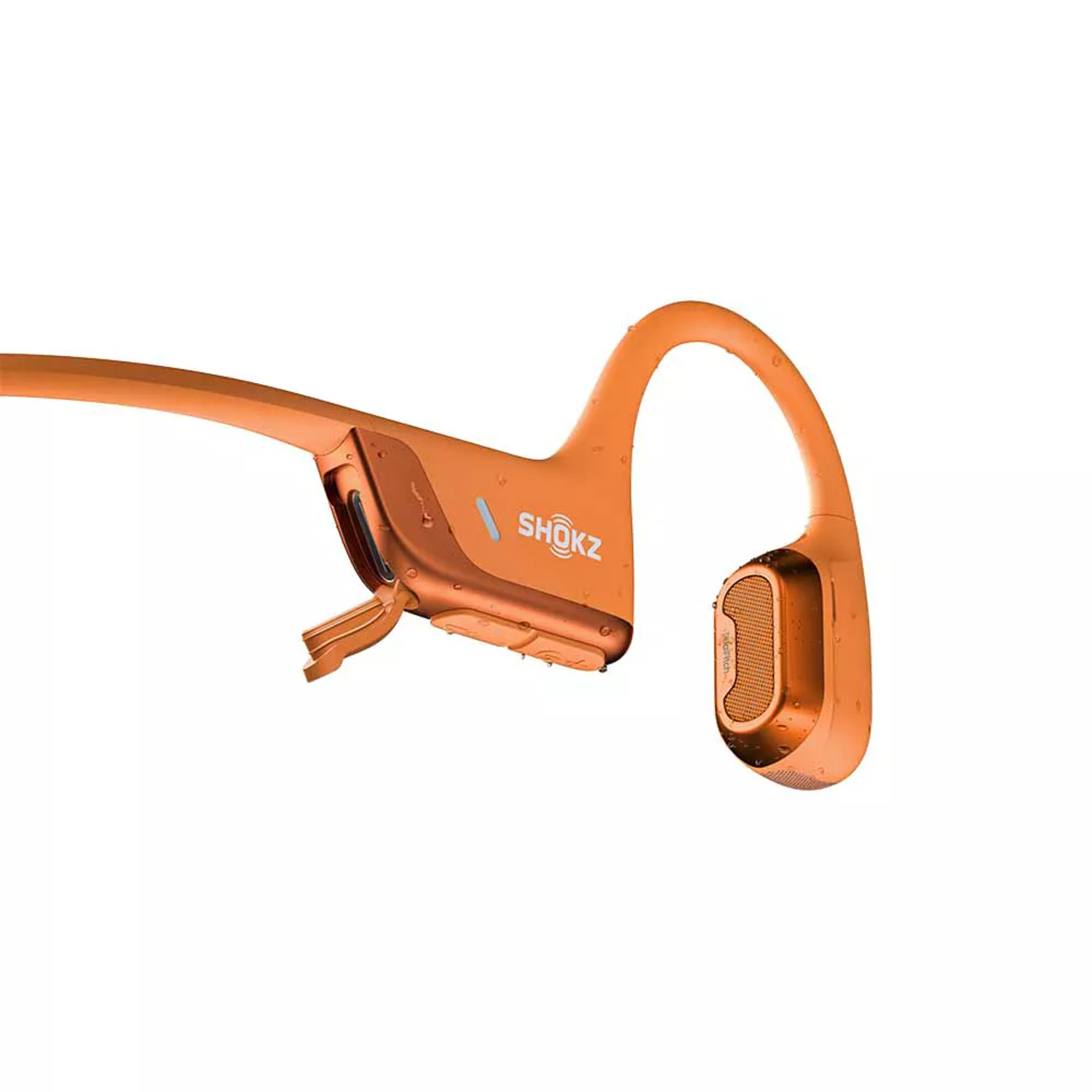 Oranje Shokz koptelefoon op witte achtergrond. De oortelefoon staat open.