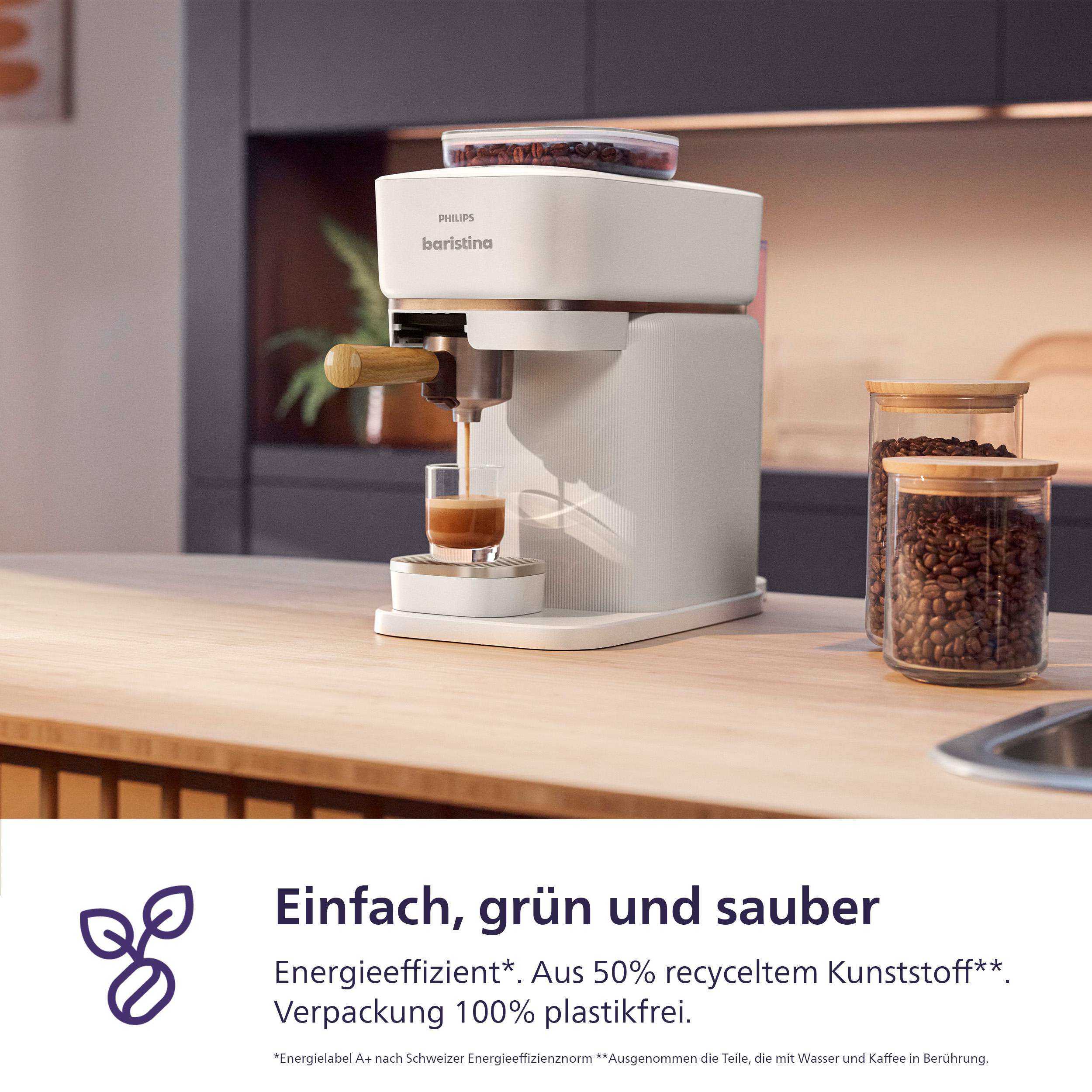Weiße Philips Baristina Kaffeemaschine auf Theke. Kaffeebohnen in Gläsern.