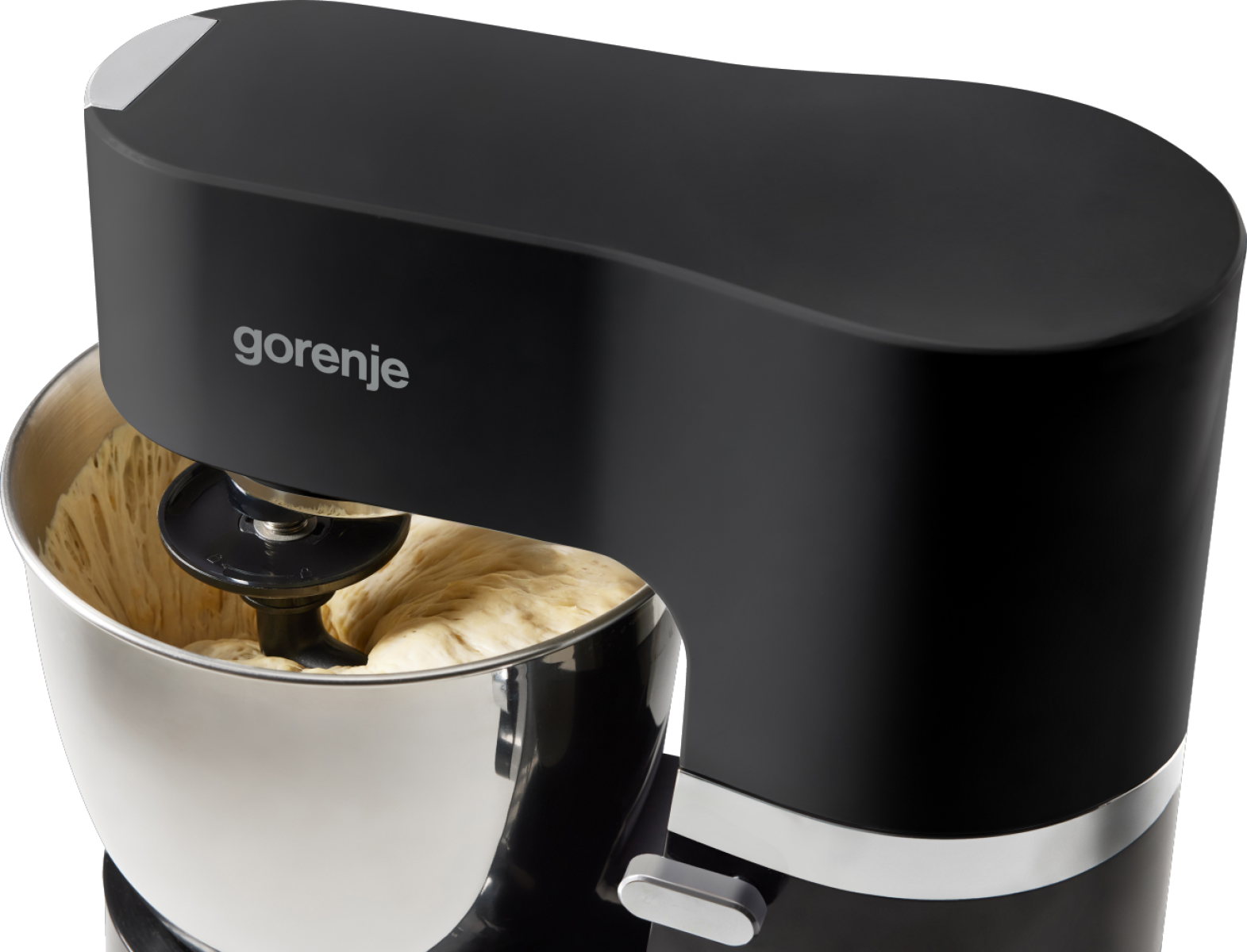 Egy fekete Gorenje robotgép tésztával egy ezüst tálban. A gép elegáns dizájnnal rendelkezik, ezüstös részletekkel.