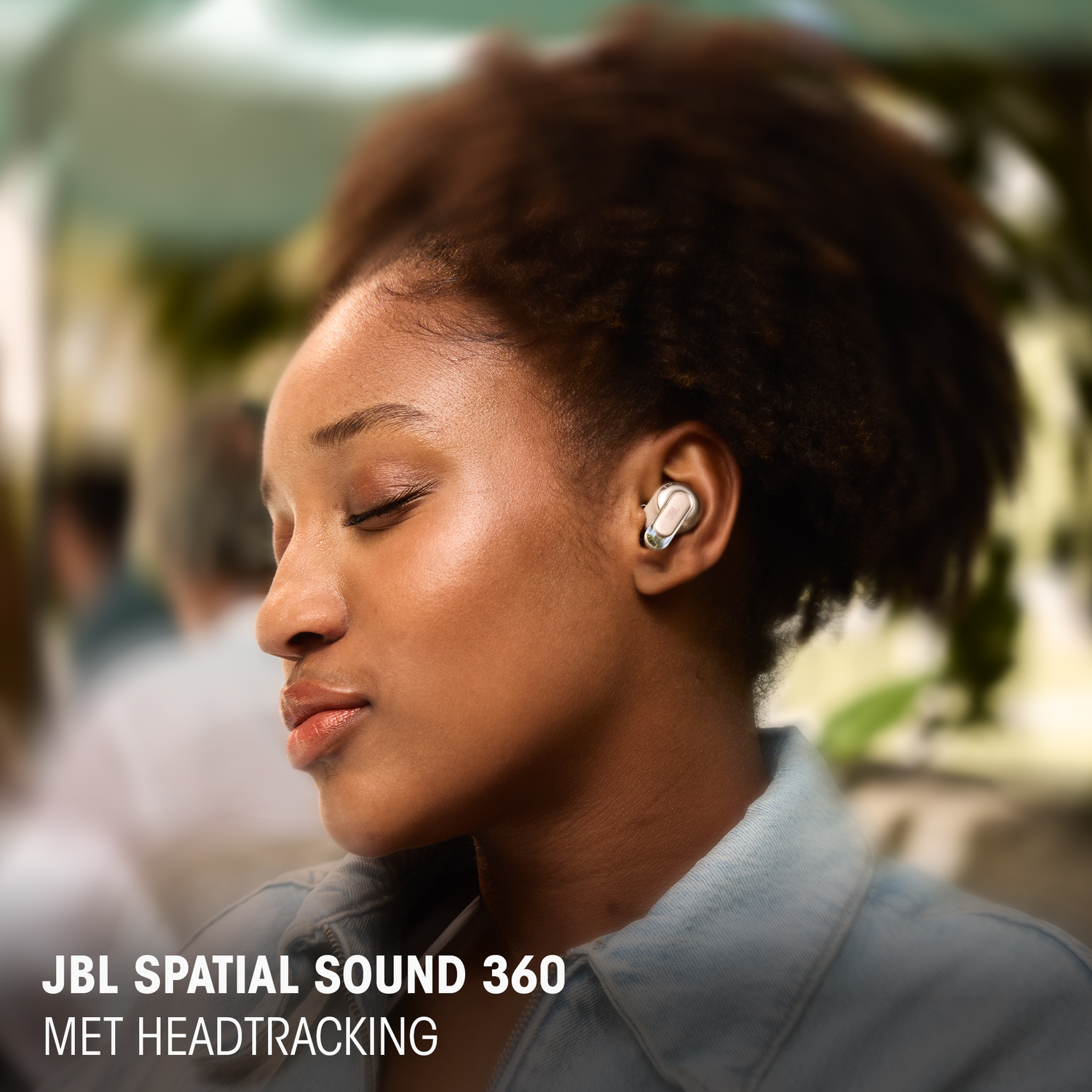 Woman wearing white earbuds, showing the product name at the bottom of the photo.