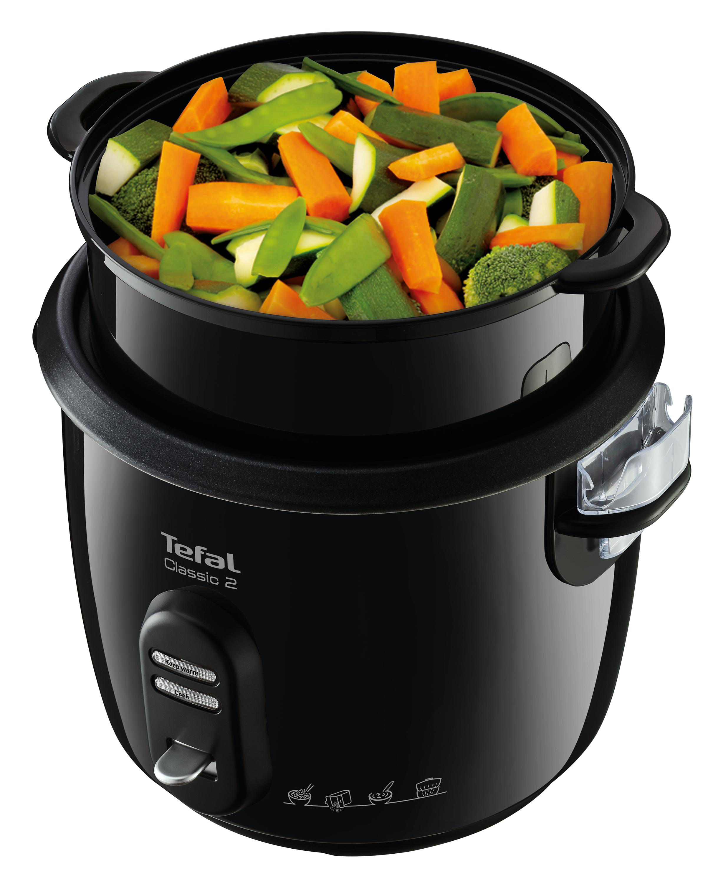 Ein schwarzer Tefal Reiskocher mit Gemüse, das darin gedünstet wird.