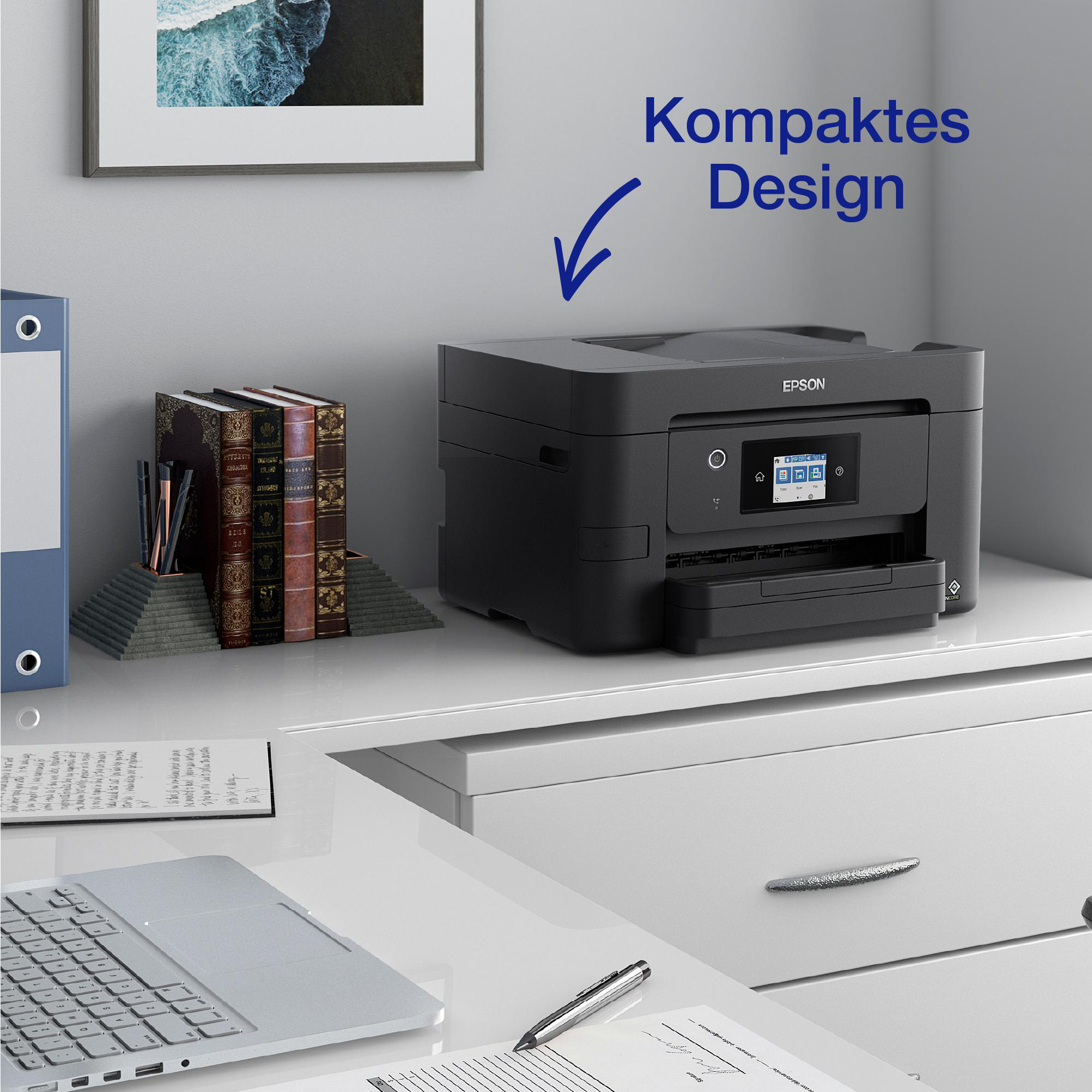 Epson-Drucker auf einem Schreibtisch mit Büchern und Laptop. Weißer Hintergrund.