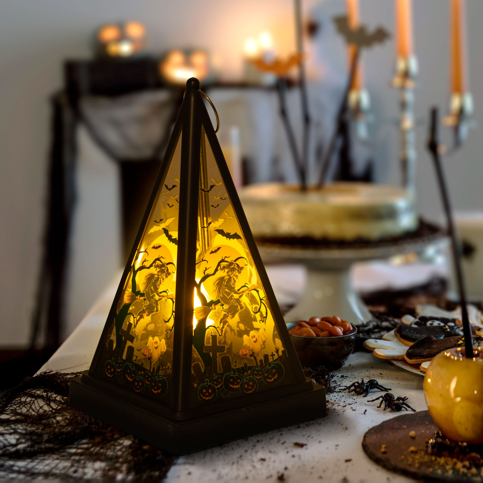 Egy világító, Halloween témájú piramis lámpás hátborzongató belsővel és dekorációkkal.