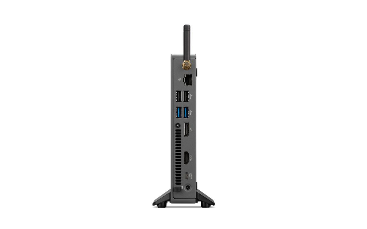 Ein kleiner, dunkelgrauer Computer mit mehreren Anschlüssen und einer Antenne, aufrecht stehend.