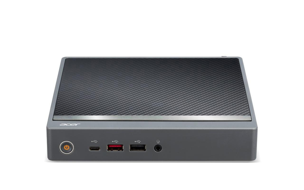 Acer Desktop-Computer. Er ist grau und hat eine Carbonfaser-Oberseite. Der Einschaltknopf leuchtet.