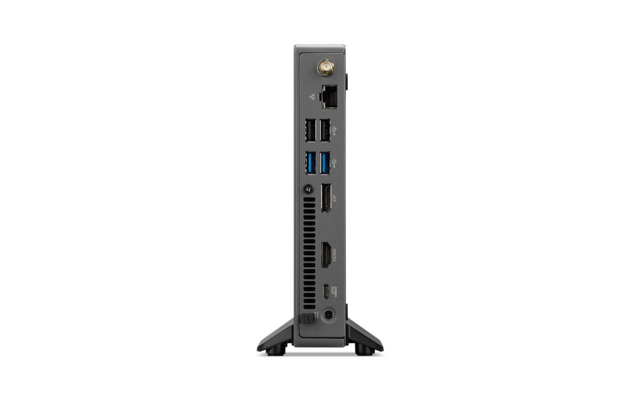 Ein grauer Computer mit mehreren Anschlüssen. Er hat einen Ständer und steht auf weißem Grund.