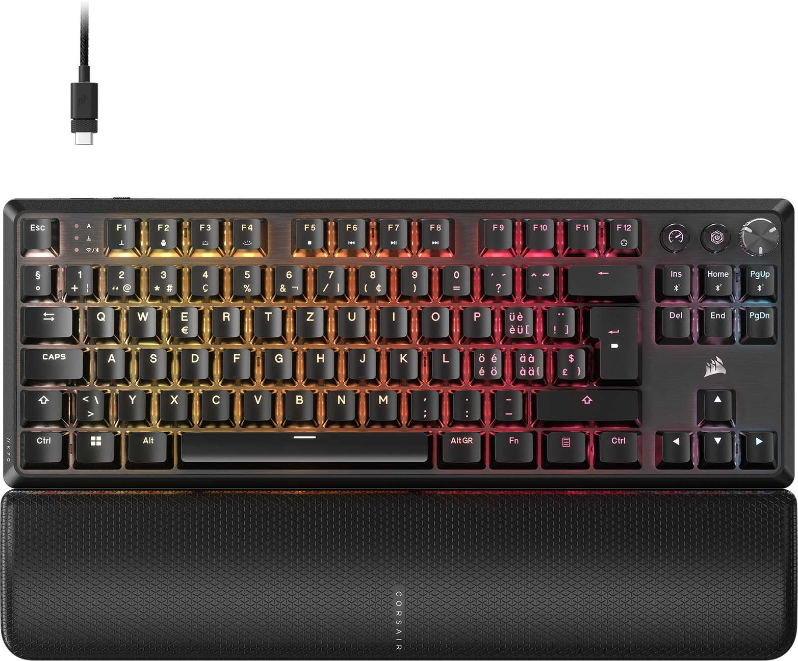 Clavier noir avec touches colorées et repose-poignet. Câble USB en haut.