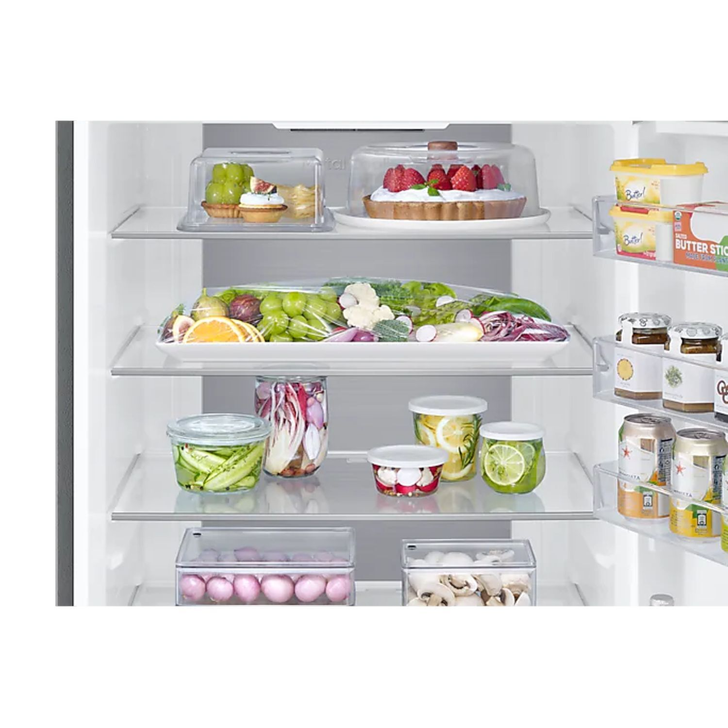 Refrigerator interior with various food items in containers and on shelves. Includes fruit and vegetables.