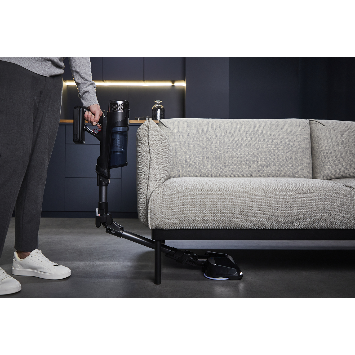 A coffee grinder with coffee beans in the top and ground coffee in a container.