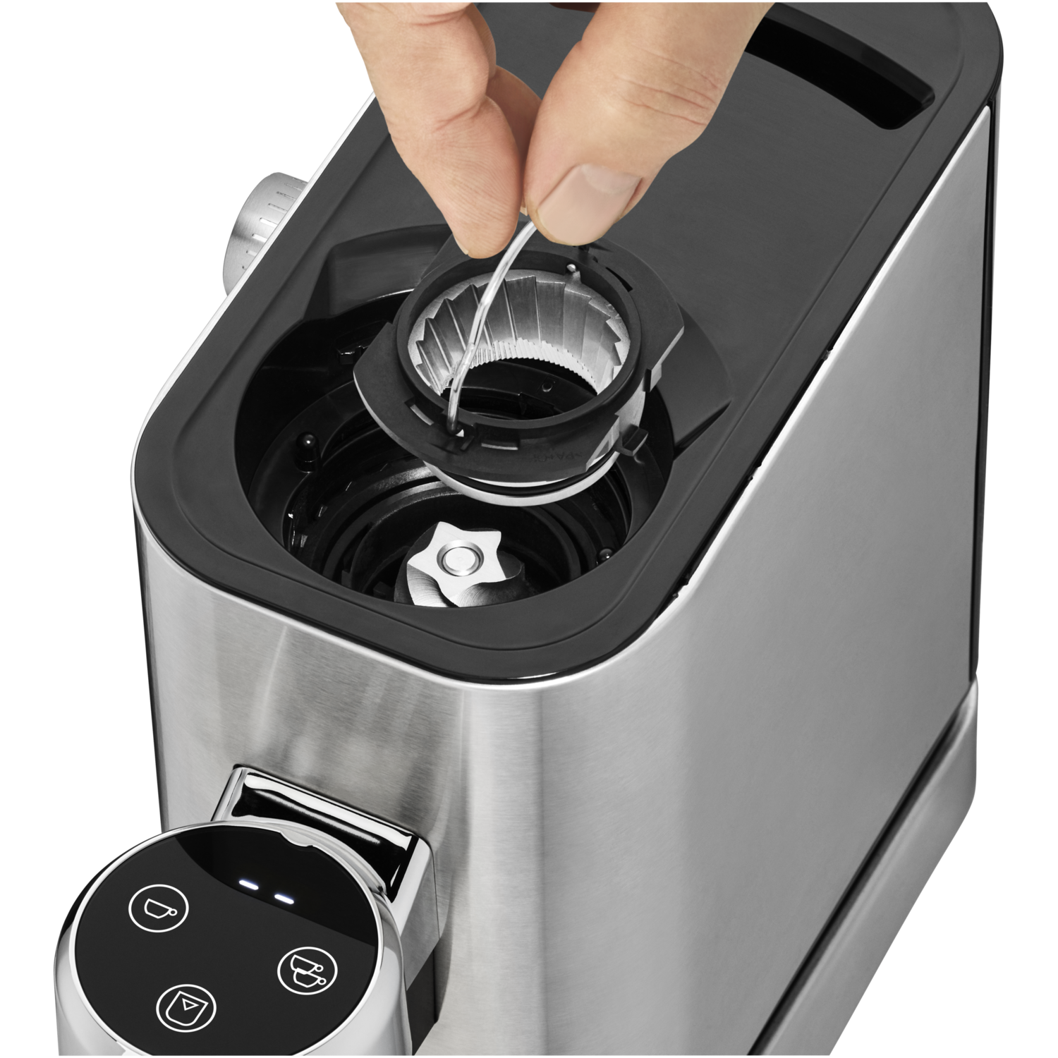 Close-up of a coffee grinder. A hand is removing a part from the top.