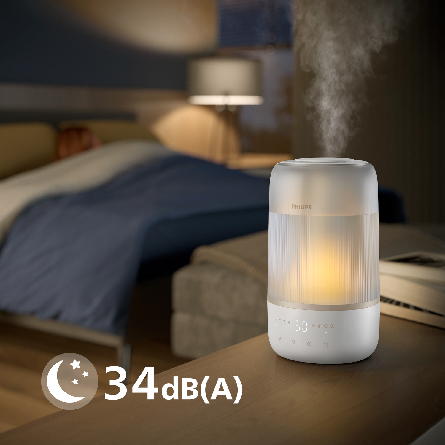 A white humidifier on a nightstand, emitting steam, with a bed and bedroom in the background.