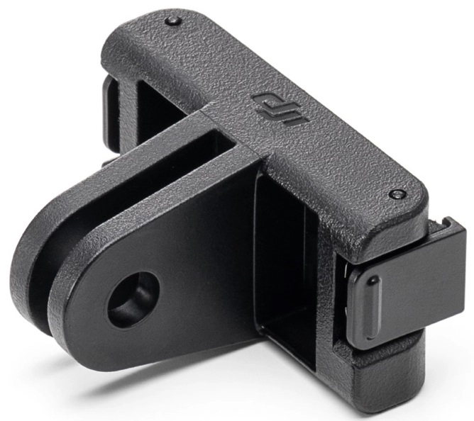 Czarny plastikowy klips. Ma dwa otwory montażowe i zawias.