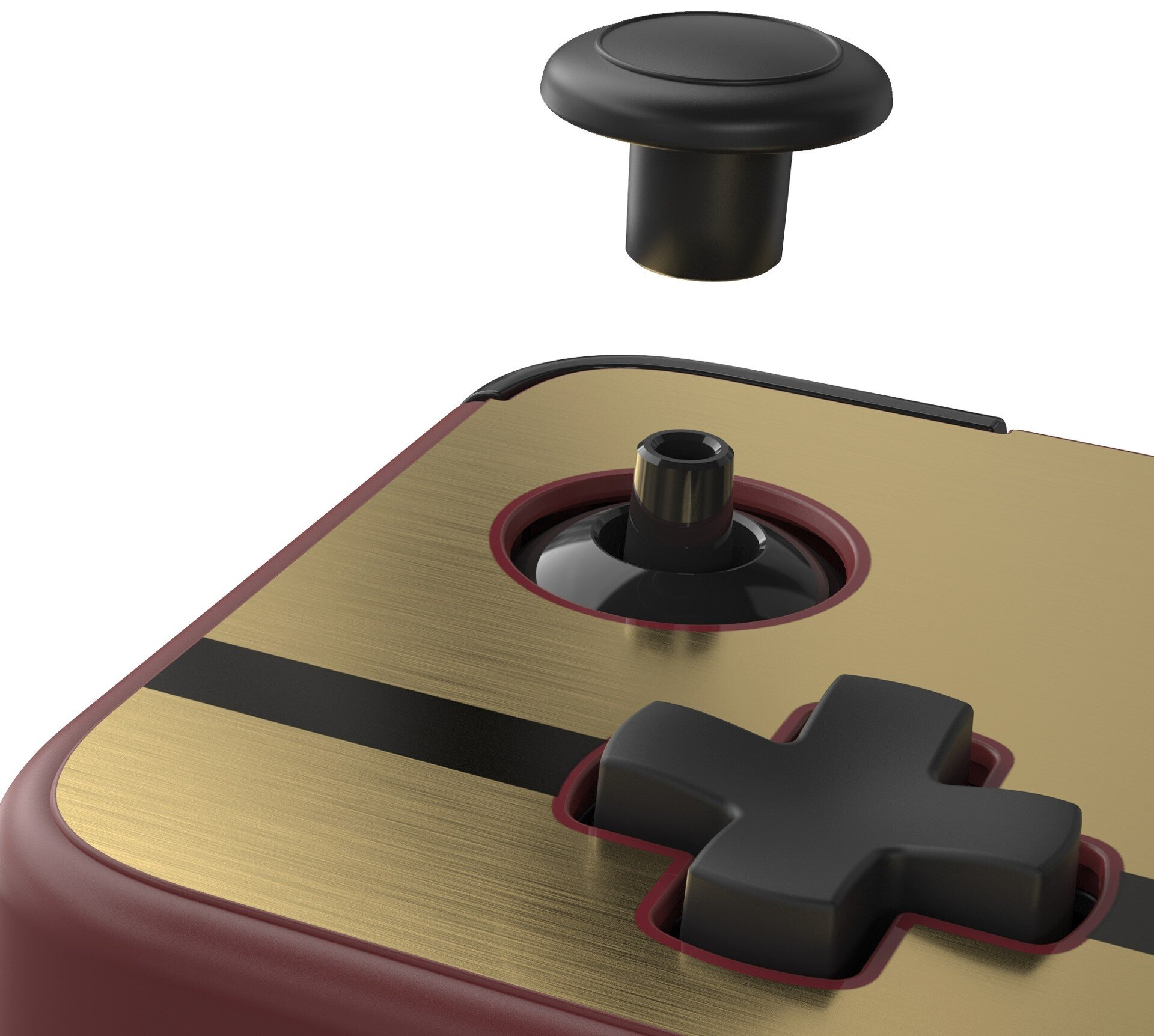 Zbliżenie góry kontrolera do gier. Czarny przycisk nad złotą powierzchnią.