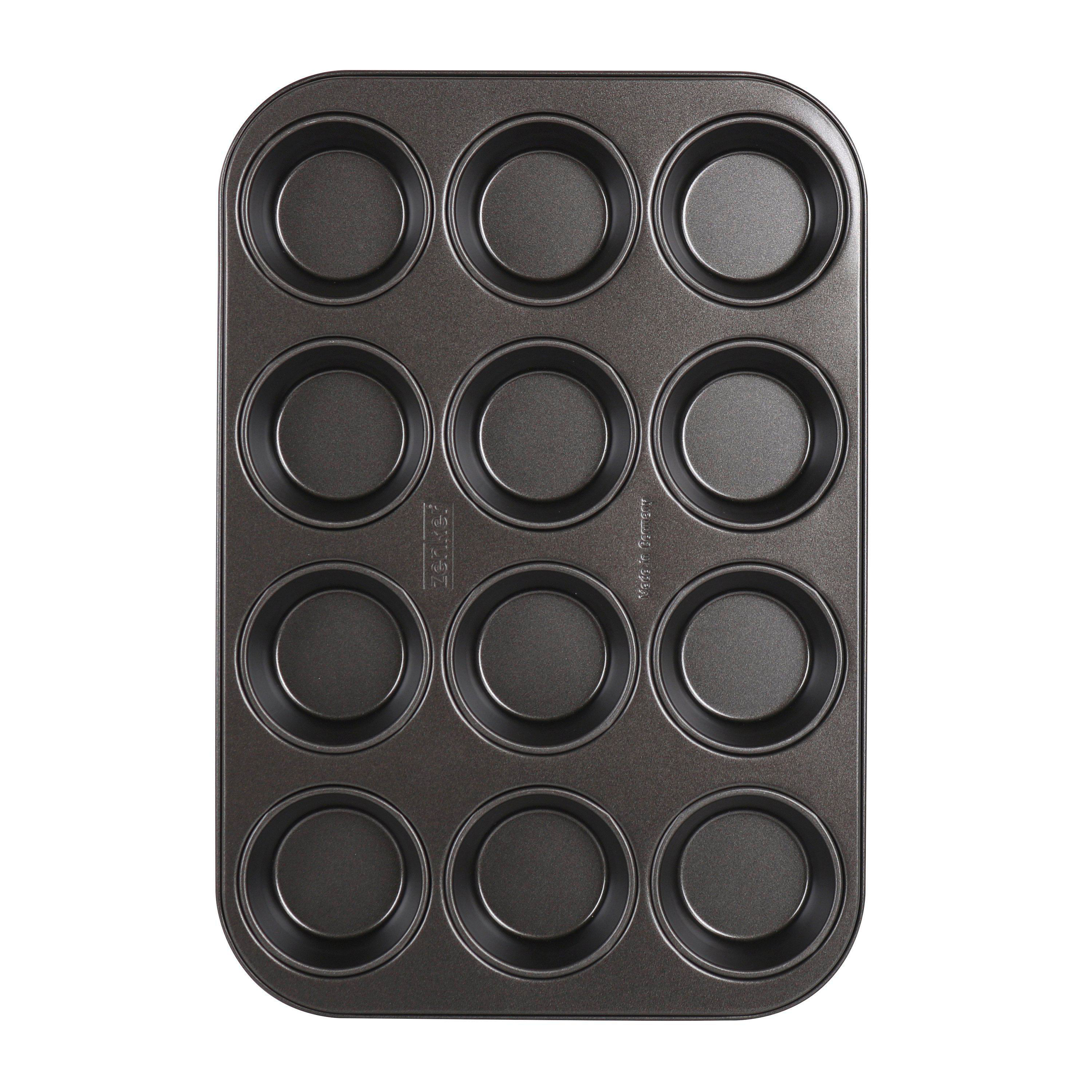 Eine leere, dunkelgraue Muffinform mit 12 runden Formen.