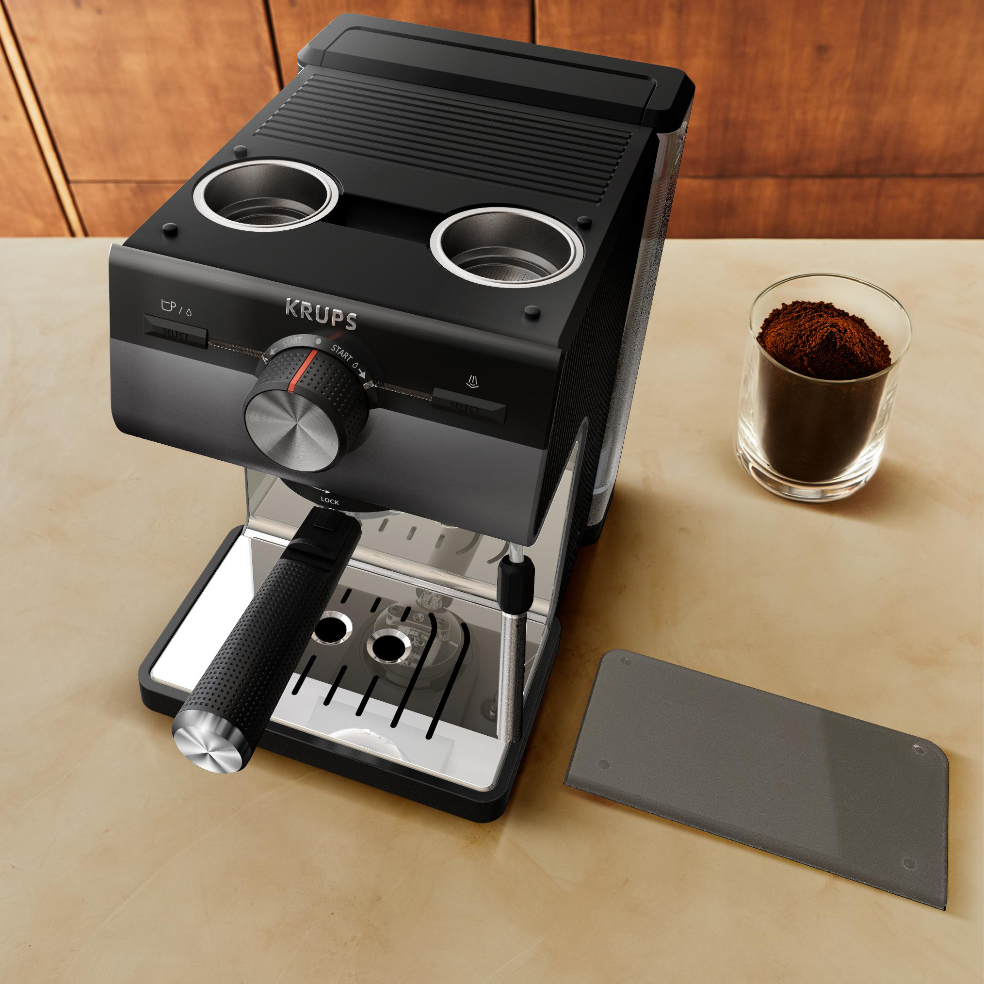 Eine schwarz-silberne KRUPS Espressomaschine mit Zubehör auf einer Theke.