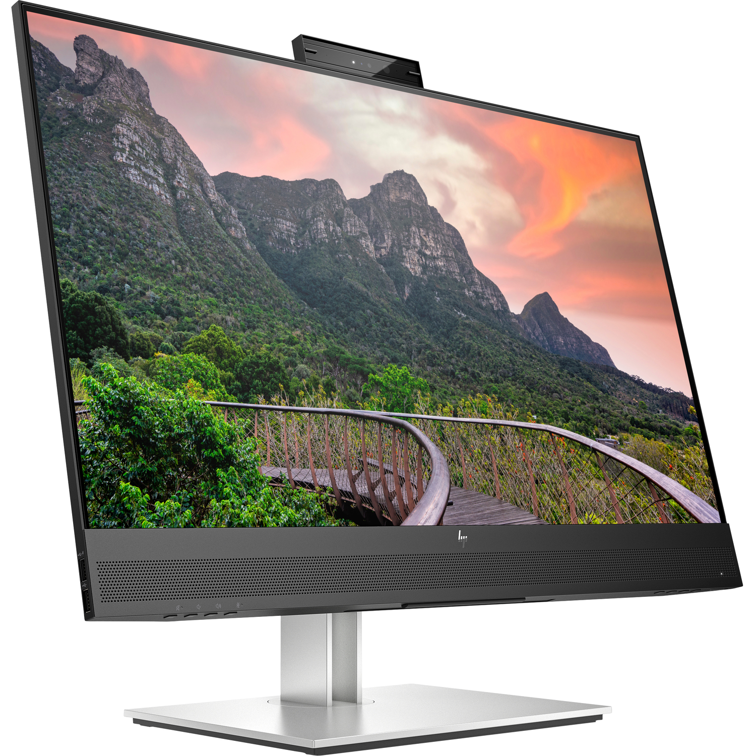 An HP all-in-one desktop computer with a large screen showing a mountain and wooden walkway scene.