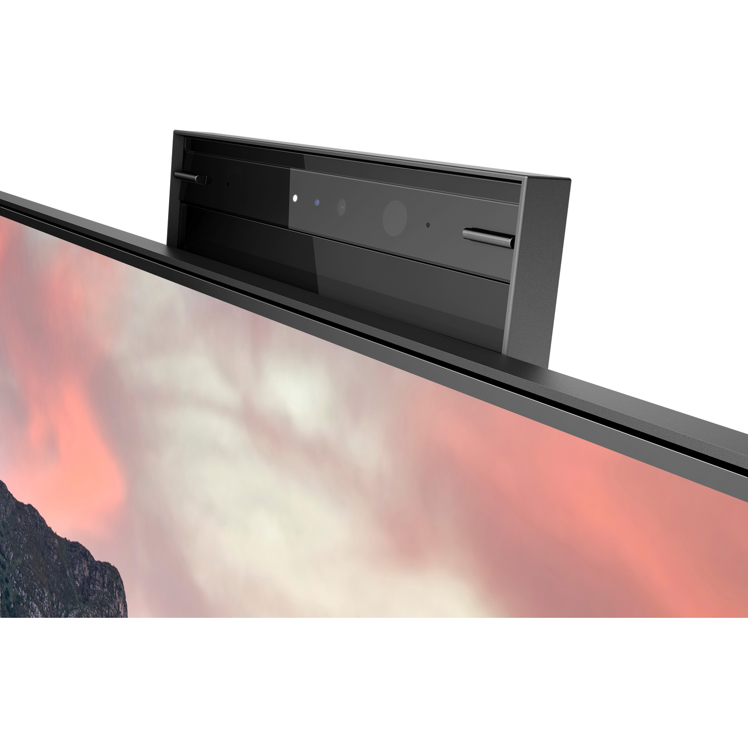 Close-up of a monitor with a webcam on top; pink and red sky background.