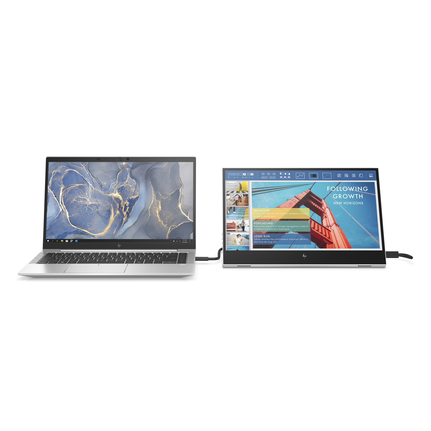 A laptop connected to a second screen. The second screen displays a red bridge and text.