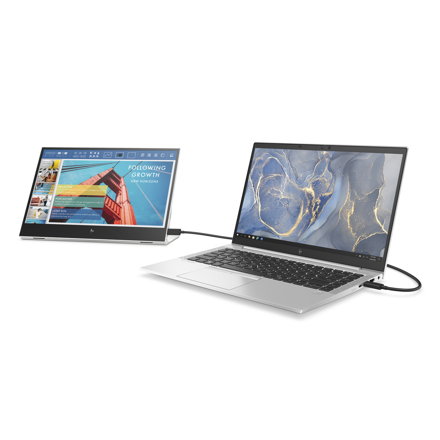 Two laptops, one with a screen showing a presentation, the other open.