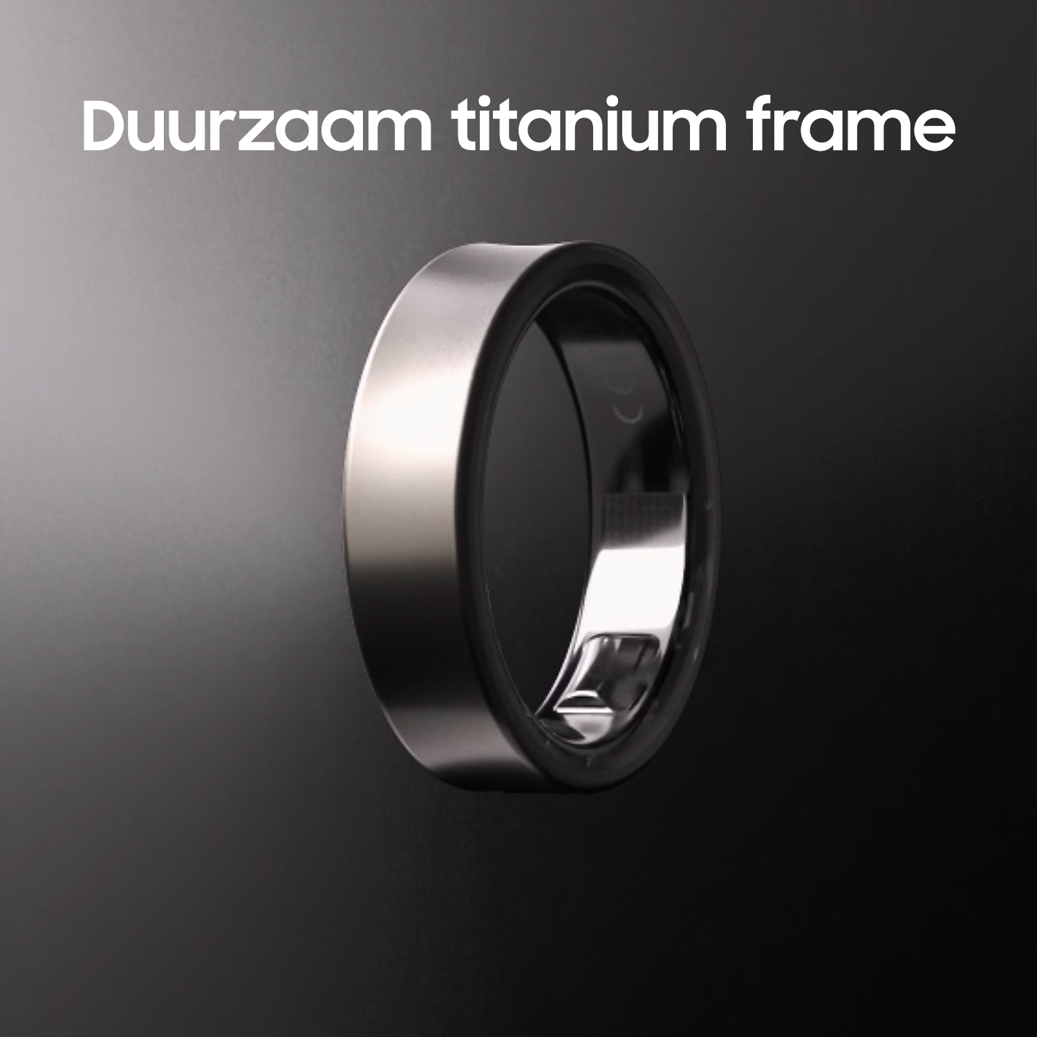 Een zilveren ring met een zwarte binnenband, weergegeven op een donker oppervlak.